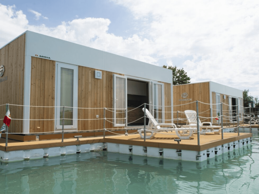 A glamping structure: a floating house on a body of water.