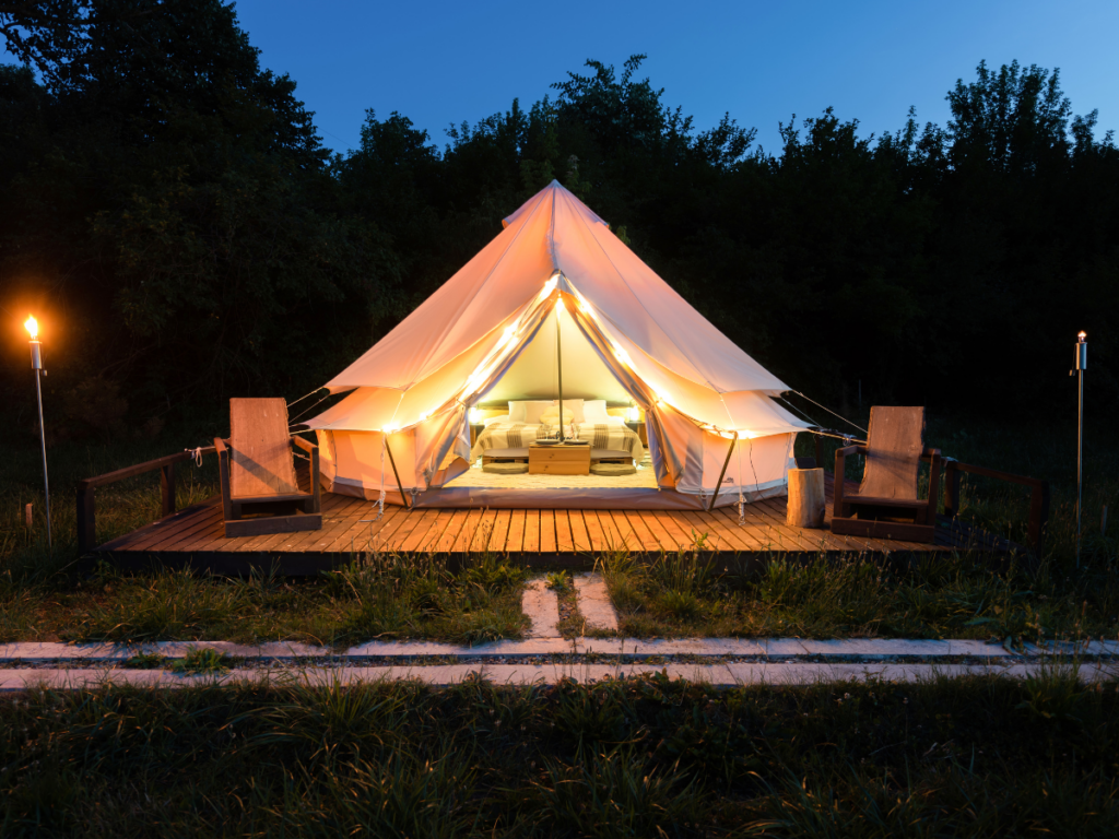 A glamping structure on a wooden deck.