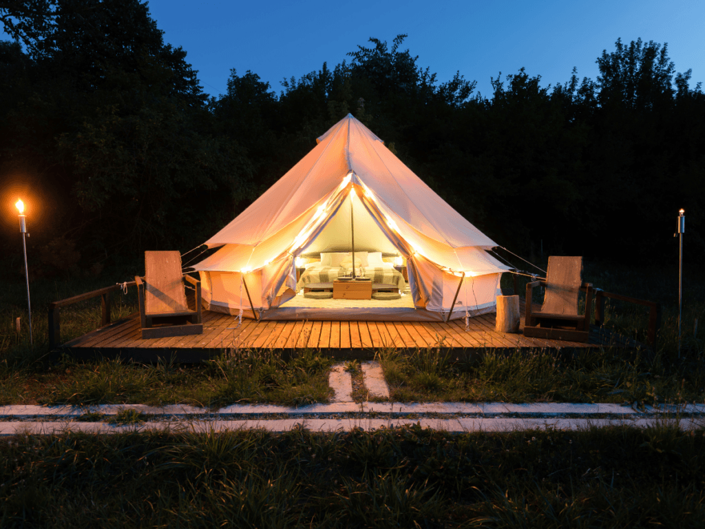 A glamping structure on a wooden deck.